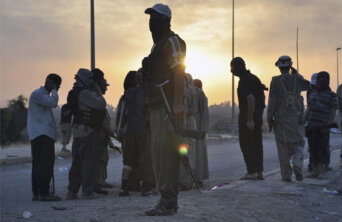 Fighters of the Islamic State of Iraq and the Levant (ISIL) stand guard at a checkpoint in the northern Iraq city of Mosul Fighters of the Islamic State of Iraq and the Levant (ISIL) stand guard at a checkpoint in the northern Iraq city of Mosul